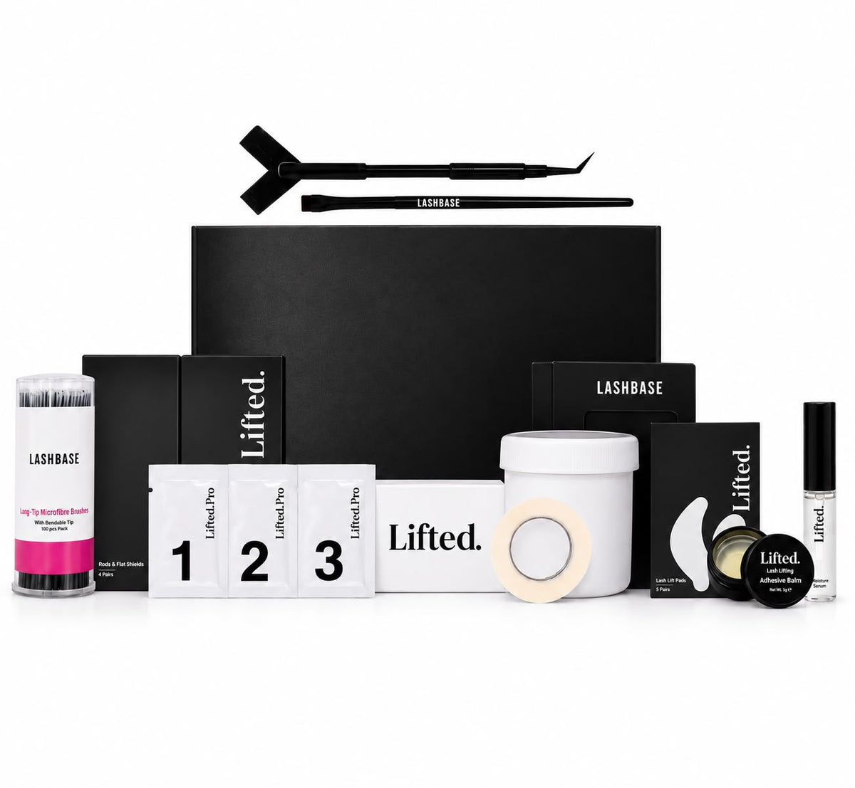 Lashbase Lifted. Lifting Kit with various black and white components including a black box, tools, cotton pads, and a white jar, arranged on a white background.