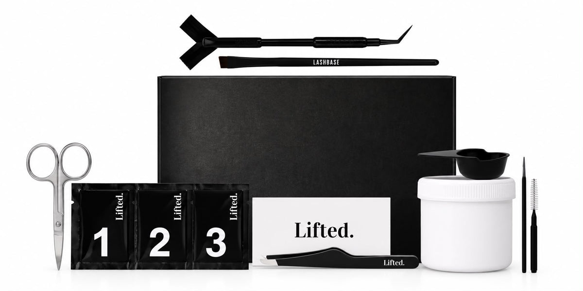 Brow lamination kit including sachets of steps 1, 2 and 3, tweezers, silver scissors, brow brush, y comb all featured on a plain white background 